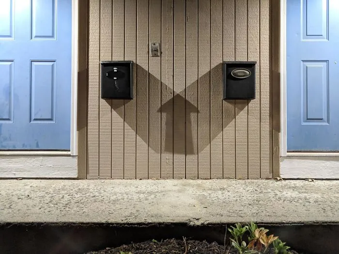 The Shadow Of Two Mailboxs Makes A Perfect Up Arrow