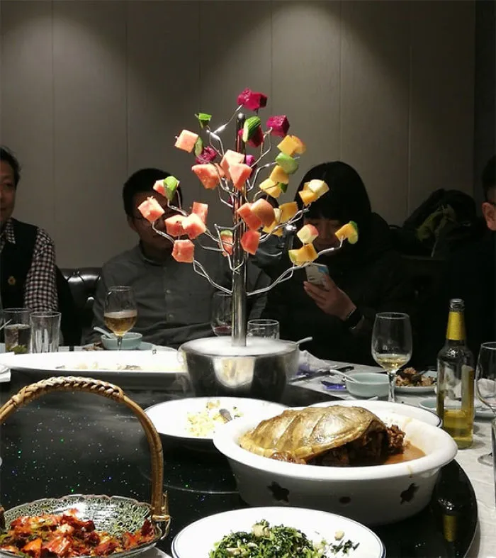 In China, Having To Pull Pieces Of Fruit Off A Tree