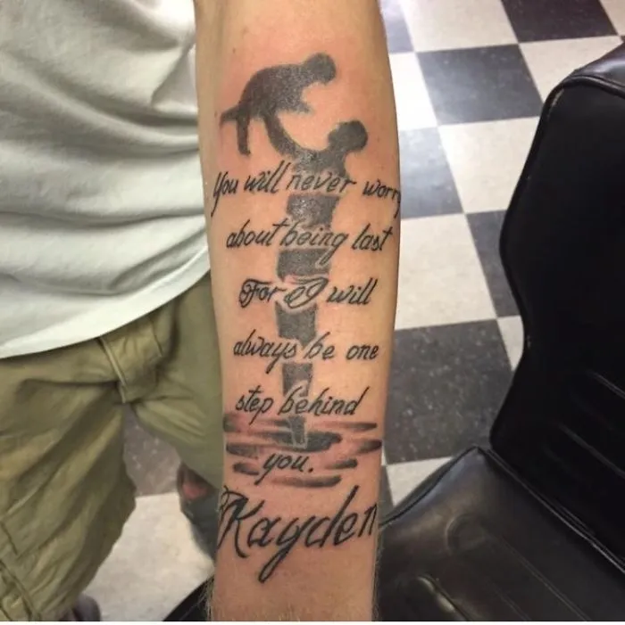 Bad tattoo fail featuring a shadowy figure and text on a forearm.