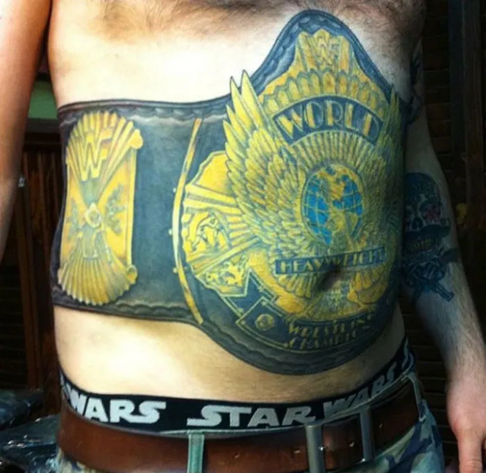A bad tattoo fail depicting a championship belt design on a man's torso, with humorous Star Wars boxers visible.