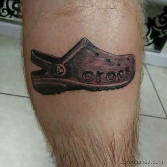 Bad tattoo fail of a Croc shoe inked on a leg.