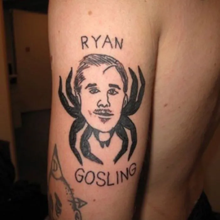 Tattoo fail featuring a portrait of a man with spider legs, labeled "Ryan Gosling," on someone's arm.