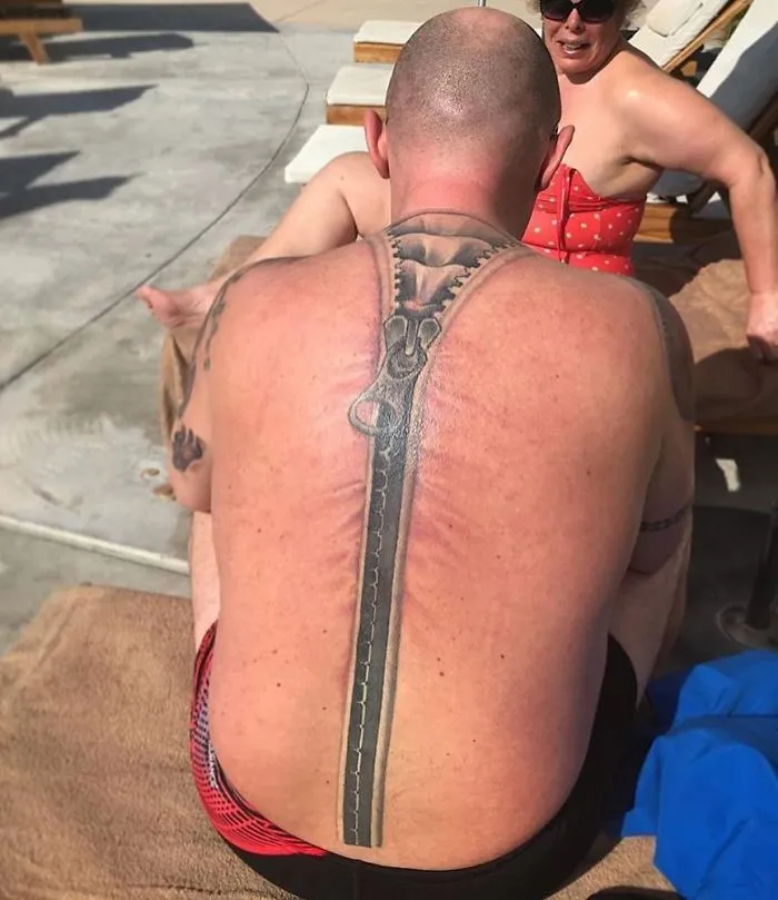 Back tattoo of a large zipper, a humorous tattoo fail under the sun.