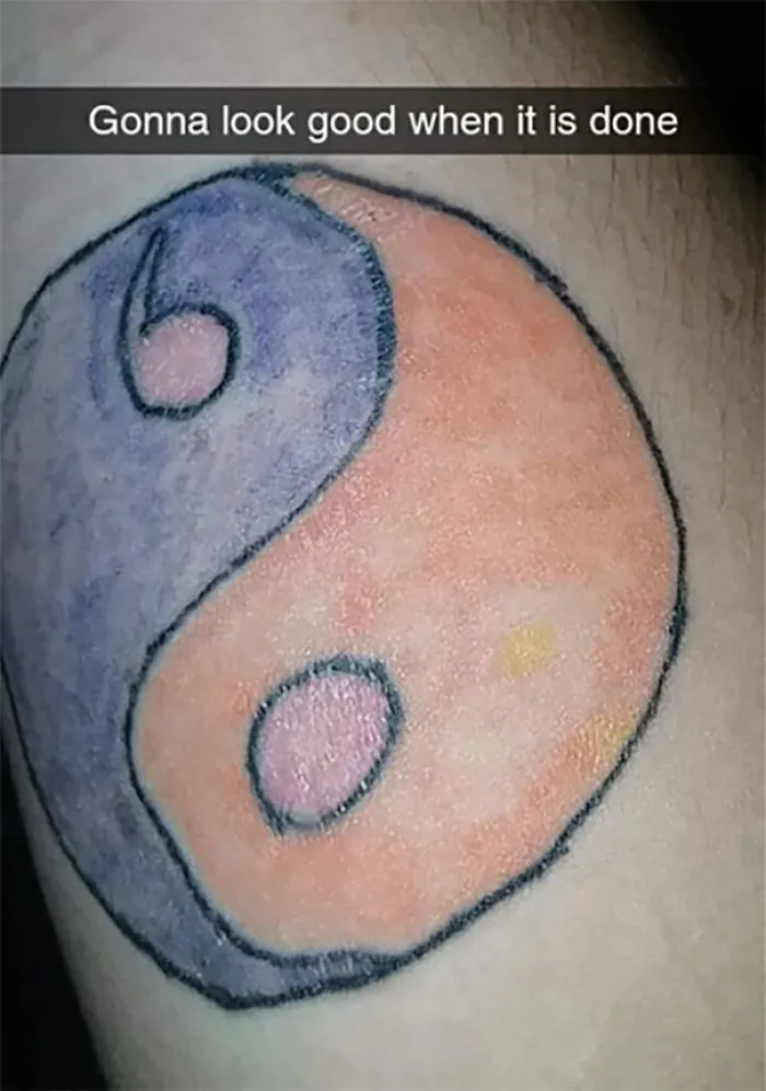 Yin yang tattoo fail with uneven colors, captioned "Gonna look good when it is done."