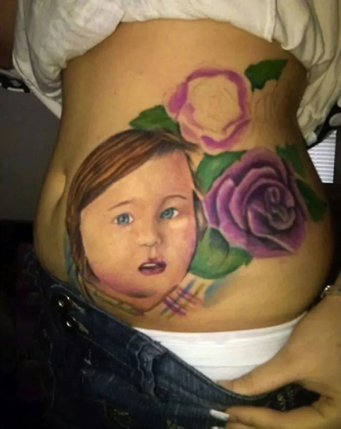 Cringe-worthy tattoo of a child and roses on a person's torso, showcasing a bad tattoo fail with awkward proportions.