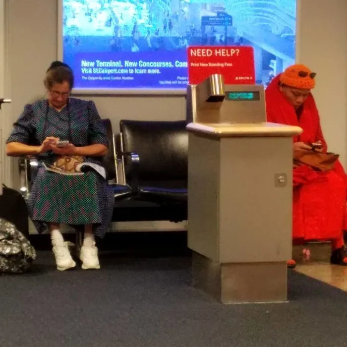 A Mennonite And A Buddhist Monk... Both On Cellphones At The Airport. You Can't Make This Stuff Up