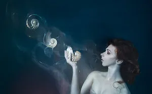 I Performed Underwater Holding Dissolving Shells To Convey The Effects Of Ocean Acidification