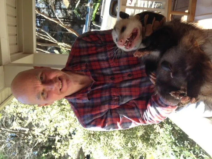 Husband With Possum And Baby