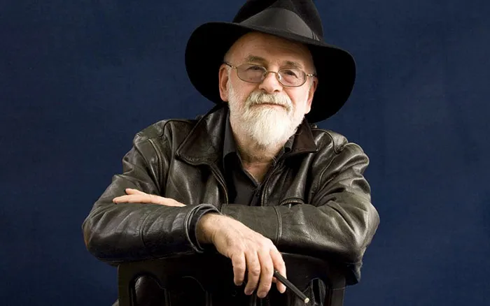 Terry Pratchett wearing black clothes and smiling