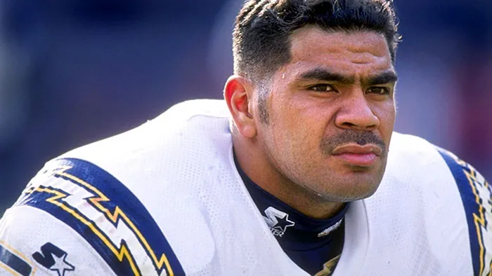 Junior Seau wearing American football outfit and looking