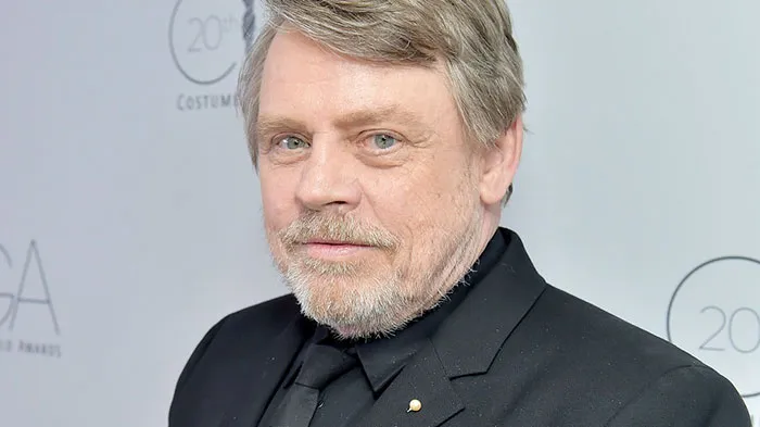 Mark Hamill wearing suit and smiling