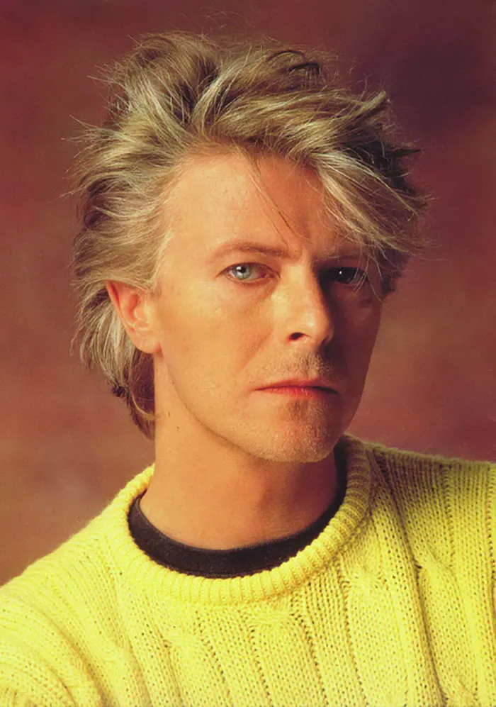 David Bowie wearing yellow sweater