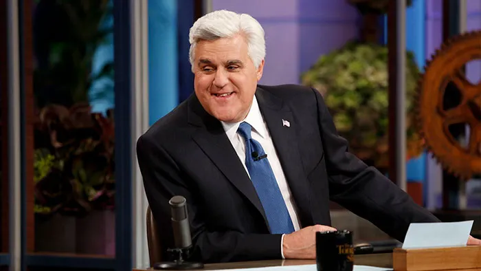 Jay Leno wearing suit and smiling