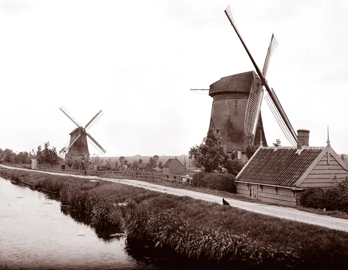 Two Windmills Along A Canal In Landsmeer, Netherlands