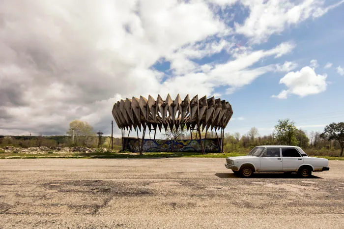 A Soviet Bus Stop Is Passed By A Soviet Car
