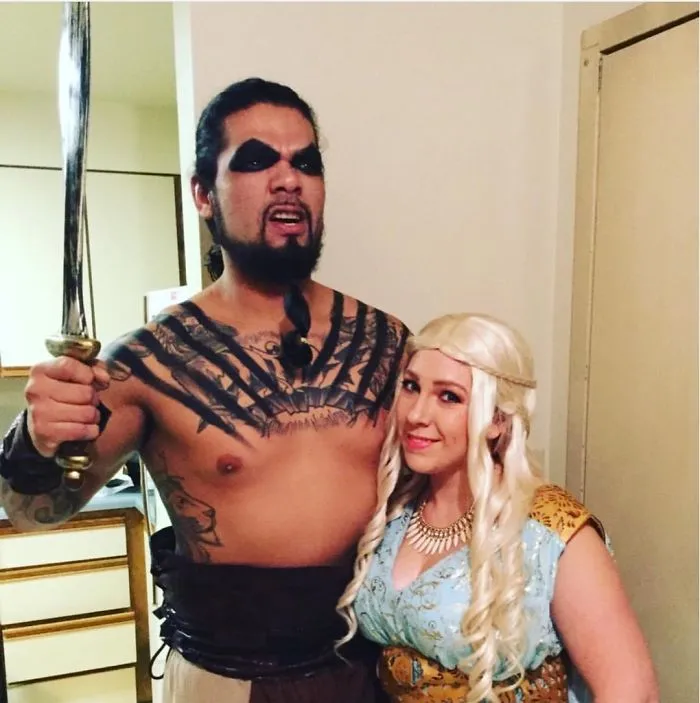 Couple dressed in elaborate costumes for Halloween, showcasing creative attire and makeup.