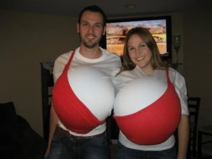 Funny couples Halloween costume ideas with a man and woman dressed up together as a giant red and white bra.