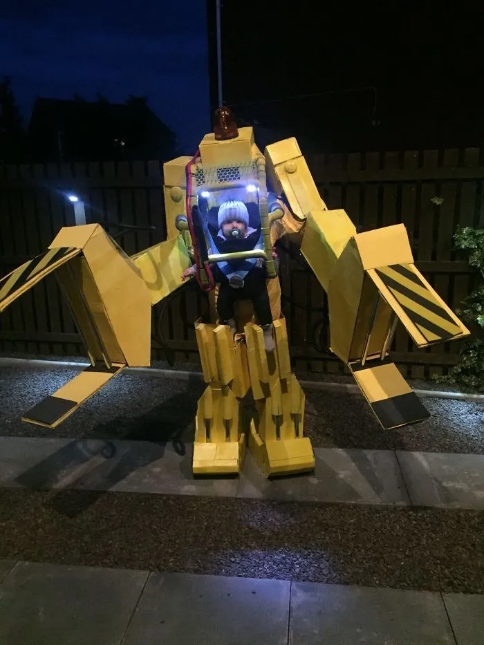 Toddler in a massive yellow mech suit loader, an impressive DIY Halloween costume idea
