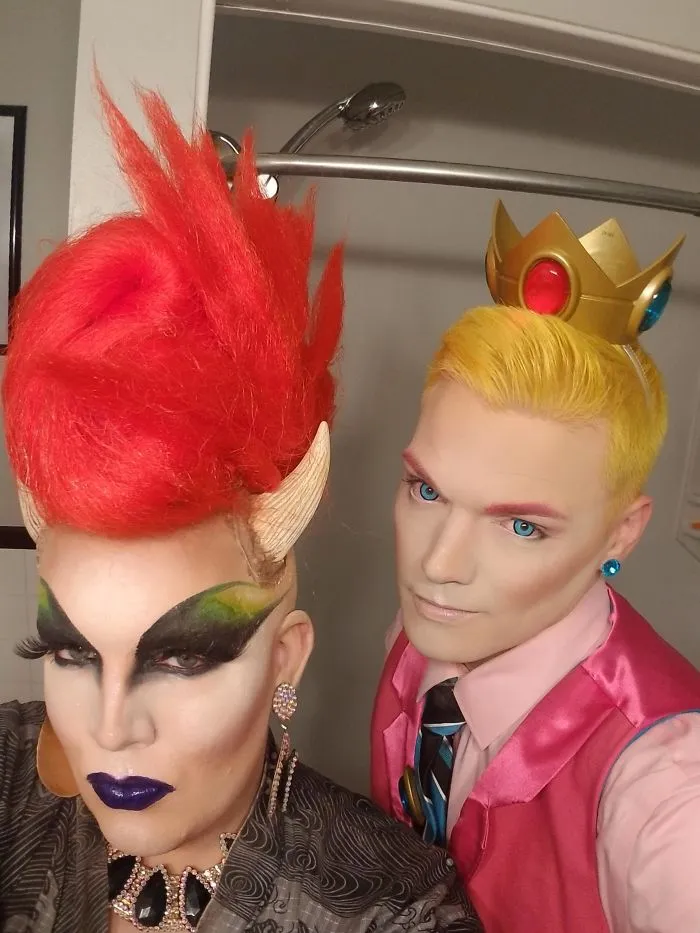 A creative Halloween costume idea featuring two people dressed as Bowsette and Princess Peach in vivid drag makeup.