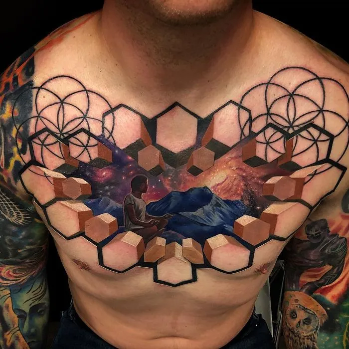 3D tattoo on a man's chest featuring geometric shapes, a meditative figure, and a cosmic landscape.