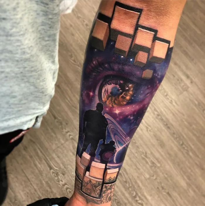 3D tattoo of a cosmic scene with an eye, silhouettes, and geometric shapes on a forearm.
