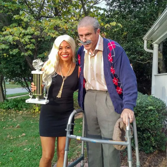 Couples Halloween costume ideas showing an old man with a walker and a young trophy wife holding an award.
