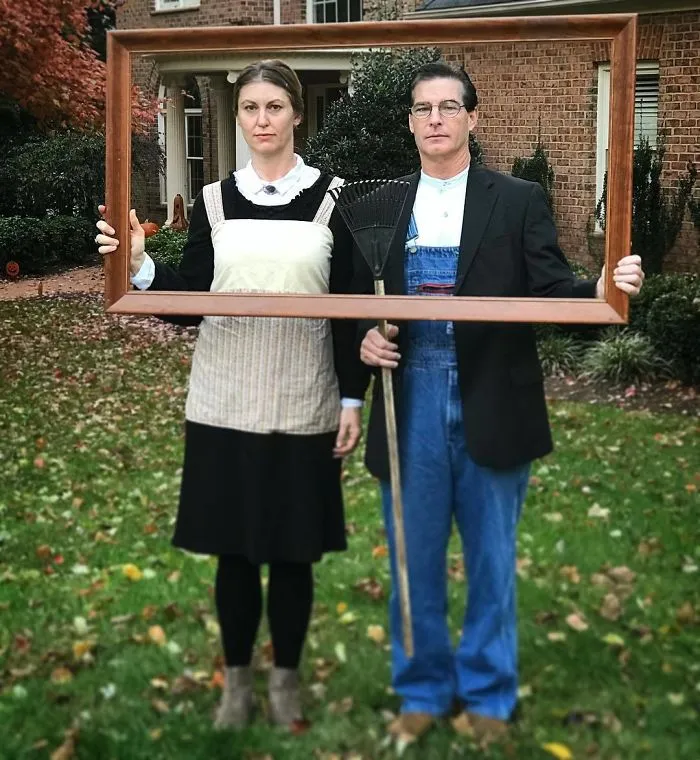A couple recreating American Gothic inside a picture frame for a clever couples Halloween costume idea.