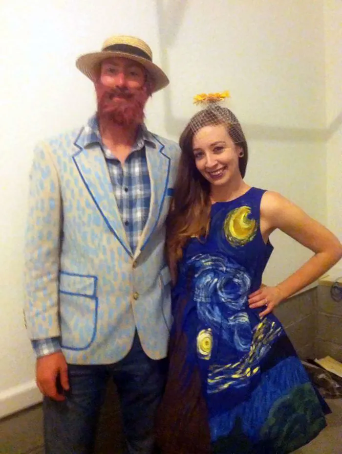 Couple in Van Gogh-inspired Halloween costumes, standing together and smiling.