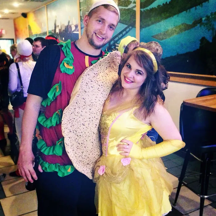 Couple dressed as a taco and Belle from Beauty and the Beast, showcasing creative Halloween costumes.