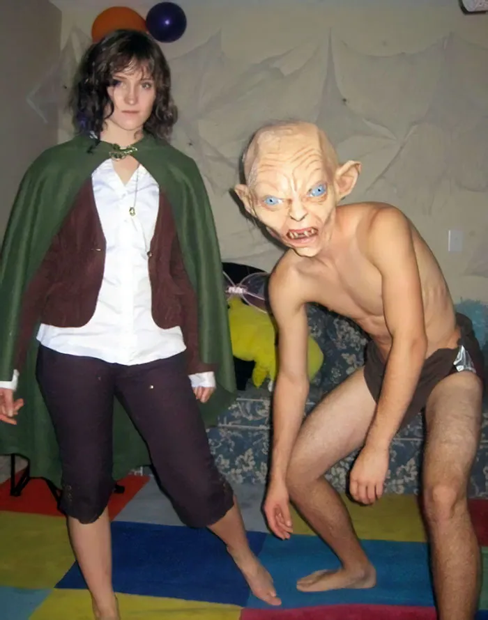 Couple in fantasy costumes, one as a cloaked character and the other as a creature, showcasing unique Halloween costumes.