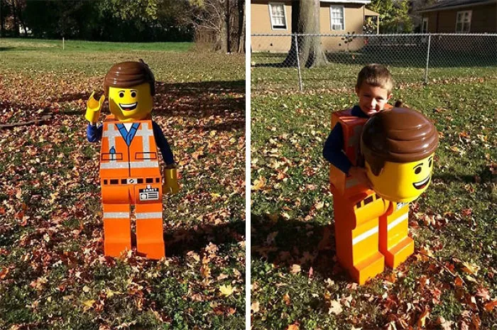 A young boy wearing a detailed Emmet Lego minifigure creative Halloween costume outdoors in the autumn leaves.
