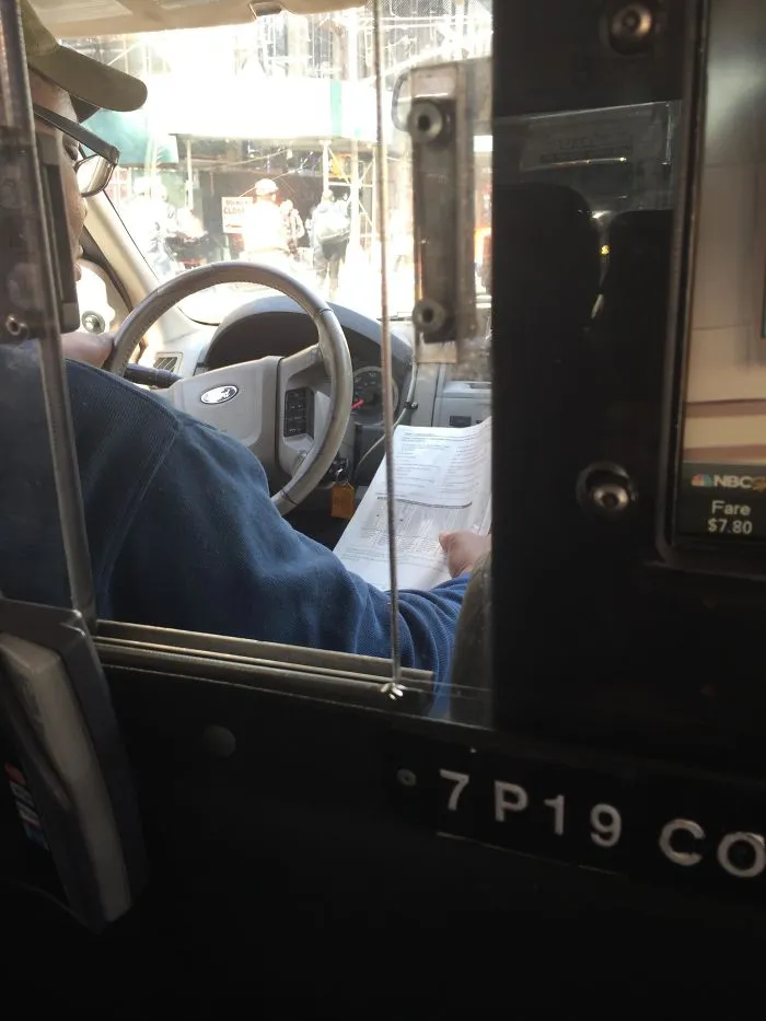 My Cab Driver Is Reading "Learning To Drive"... While Driving