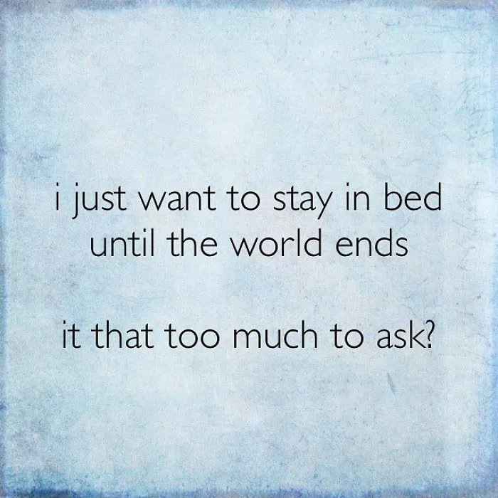 Pessimistic Instagram quote about wanting to stay in bed until the world ends on a blue textured background.