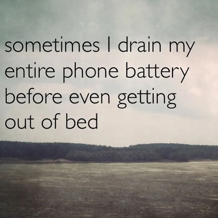 Pessimistic Instagram quote on a cloudy landscape about draining phone battery before getting out of bed.