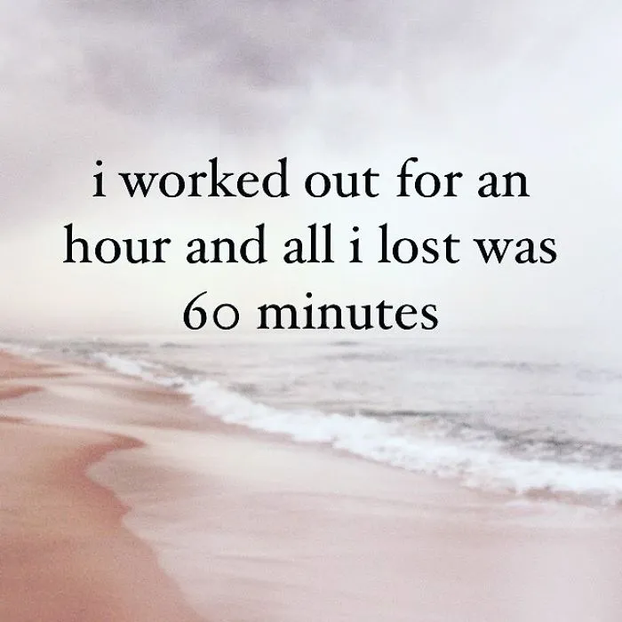 Unispirational quote on a beach background stating loss of time after working out for an hour with pessimistic humor.