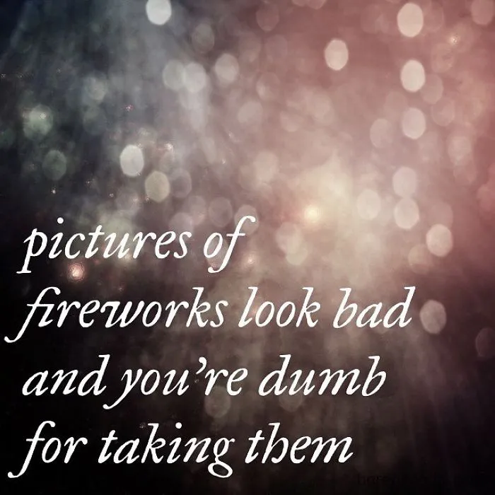 A pessimistic Instagram quote about pictures of fireworks looking bad with a blurred bokeh light background.