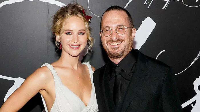 Two celebrities posing together at a formal event, illustrating celebrities who fell in love while acting together.
