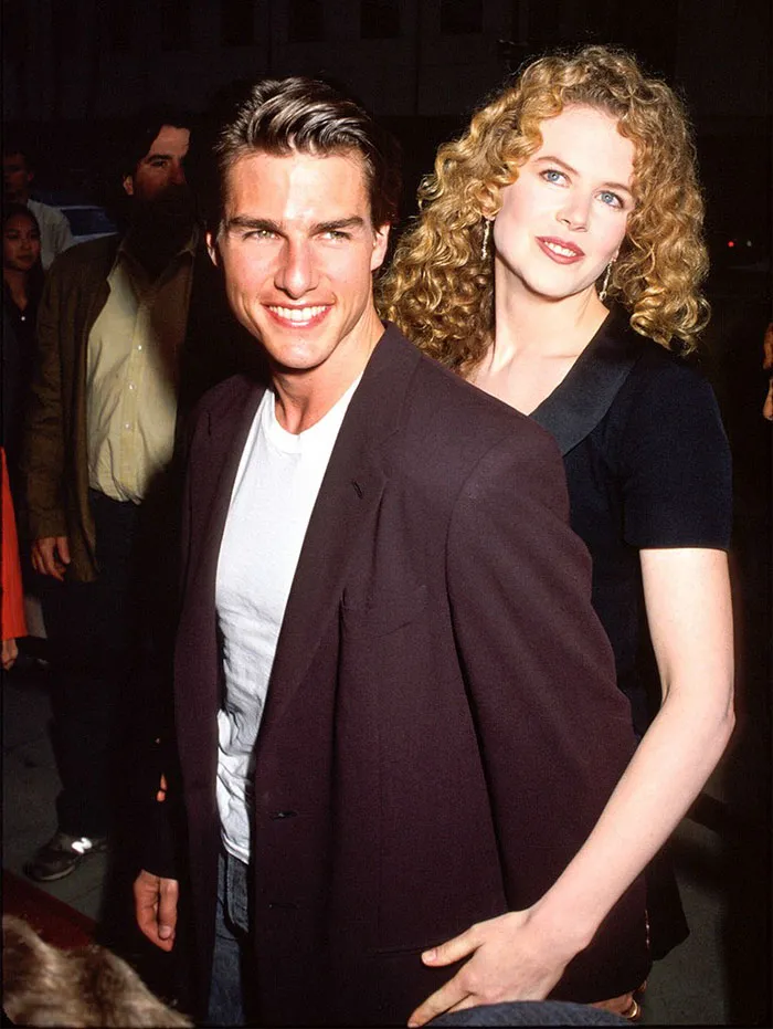 Tom Cruise and Nicole Kidman smiling together at a public event, illustrating celebrities who fell in love while acting.