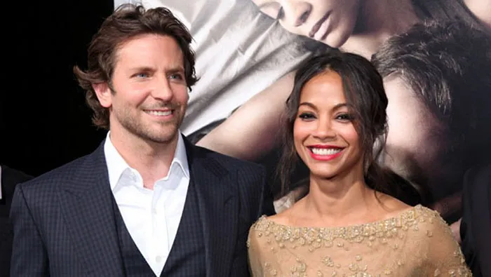 Two celebrities smiling together at a red carpet event, highlighting couples who fell in love while acting.