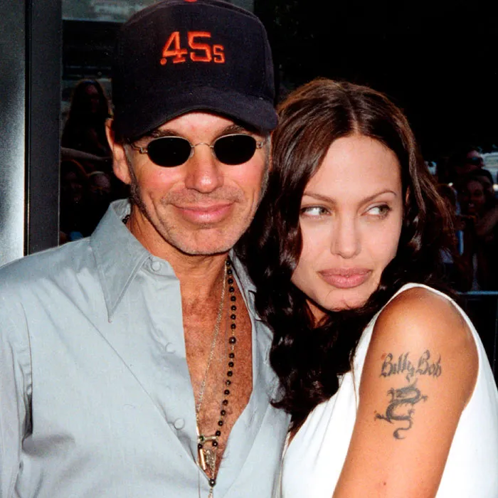 Famous couple embracing at an event, illustrating celebrities who fell in love while acting together.