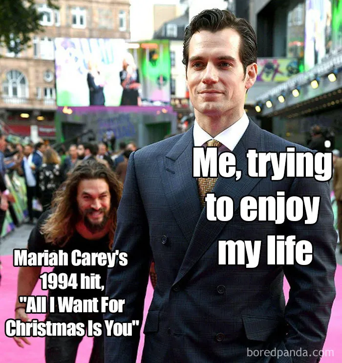 Man in a suit with humorous Christmas meme text referencing Mariah Carey's Christmas song.
