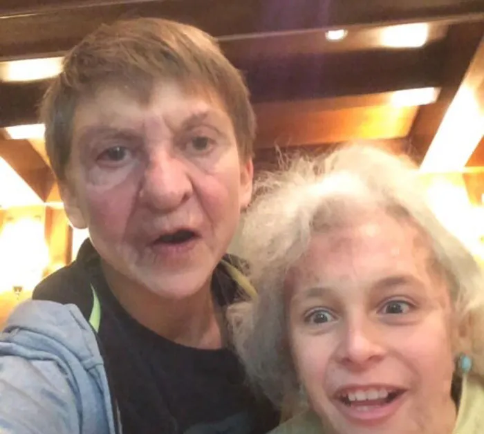 Boy and grandma using face swap filter for a selfie 