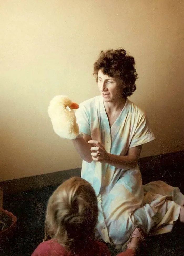 WOman preforming a puppet show for a kid 