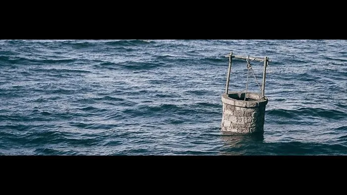 Water Well Drifting In The Open Ocean. Pejac's Latest Art Installation 'Land Adrift' Brings A Disturbing Mirage Of A Post-Apocalyptic Future