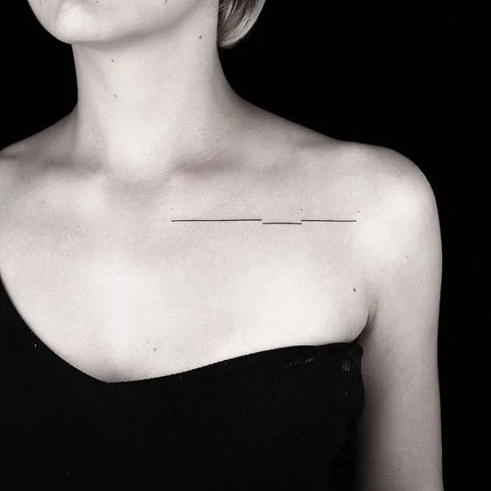 Minimalist geometric tattoo on shoulder by Turkish artist, showcasing sleek lines and elegance.