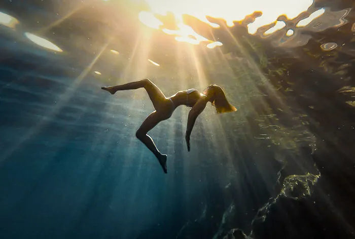 Girl Appears To Be Drinking Sun-Rays Underwater In Spectacular Photo