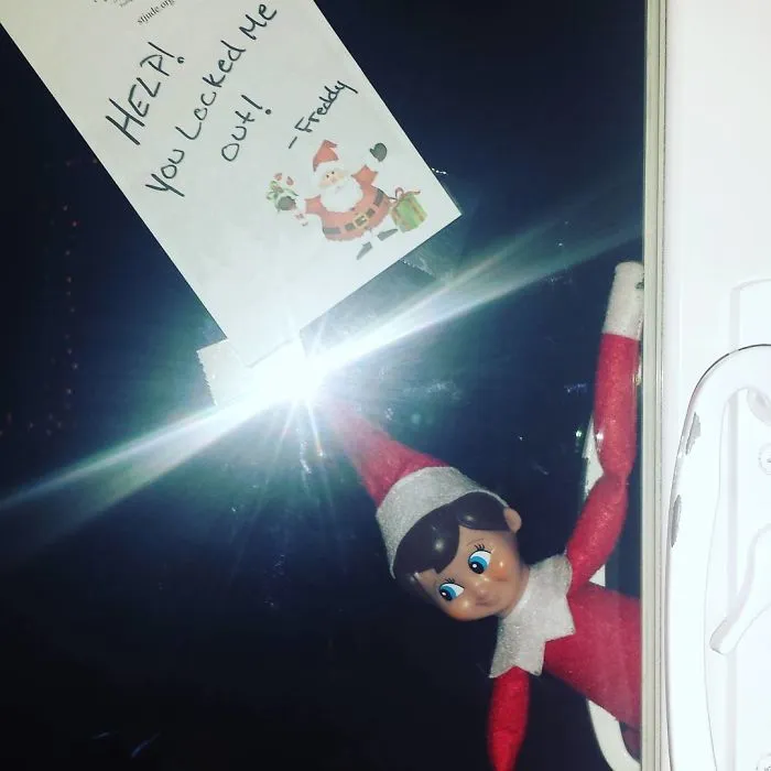 Elf On The Shelf peeking through door window holding a note saying Help You locked me out for playful mischief idea.