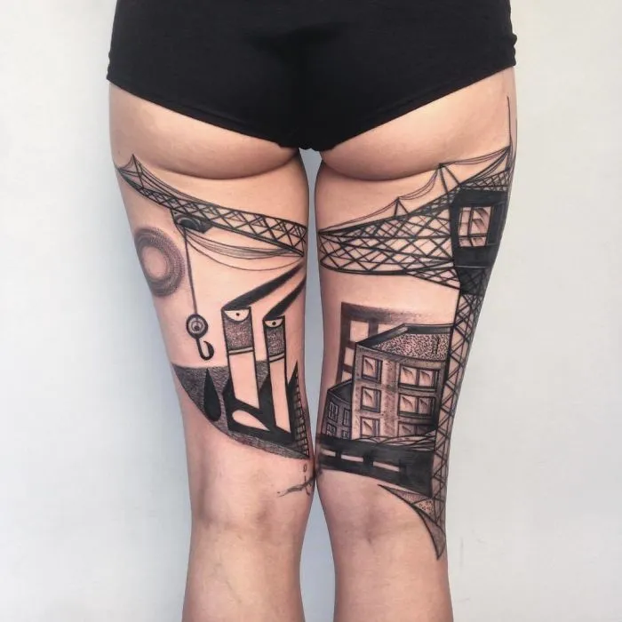 Architecture tattoo design on legs, featuring cranes and buildings for ink lovers.