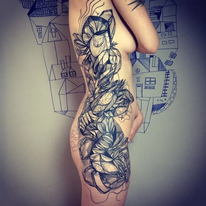 Abstract floral tattoo design covering side of torso.