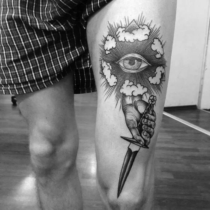 Leg tattoo with an eye and dagger design, perfect for ink lovers seeking unique tattoo ideas.